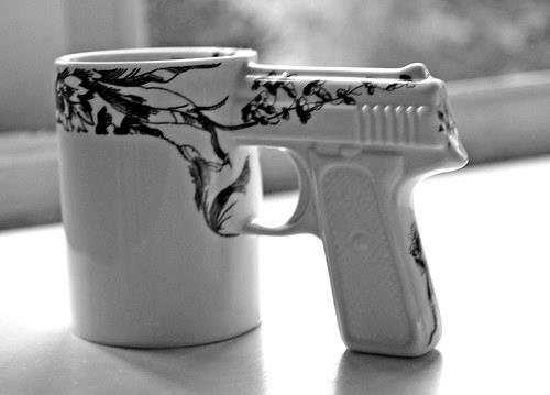 Funny sign of a coofee mug with a revolver handle. http://www.lbsommer-author.yolasite.com/gun-signs.php